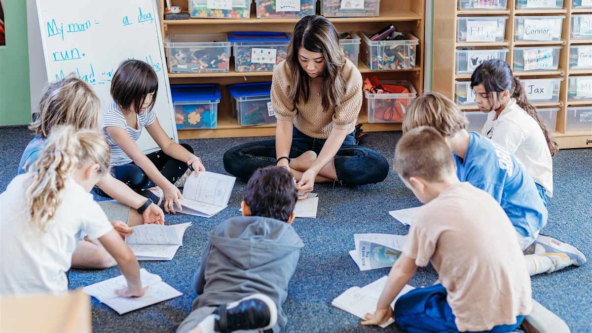A PS1 teacher leading a small group of students