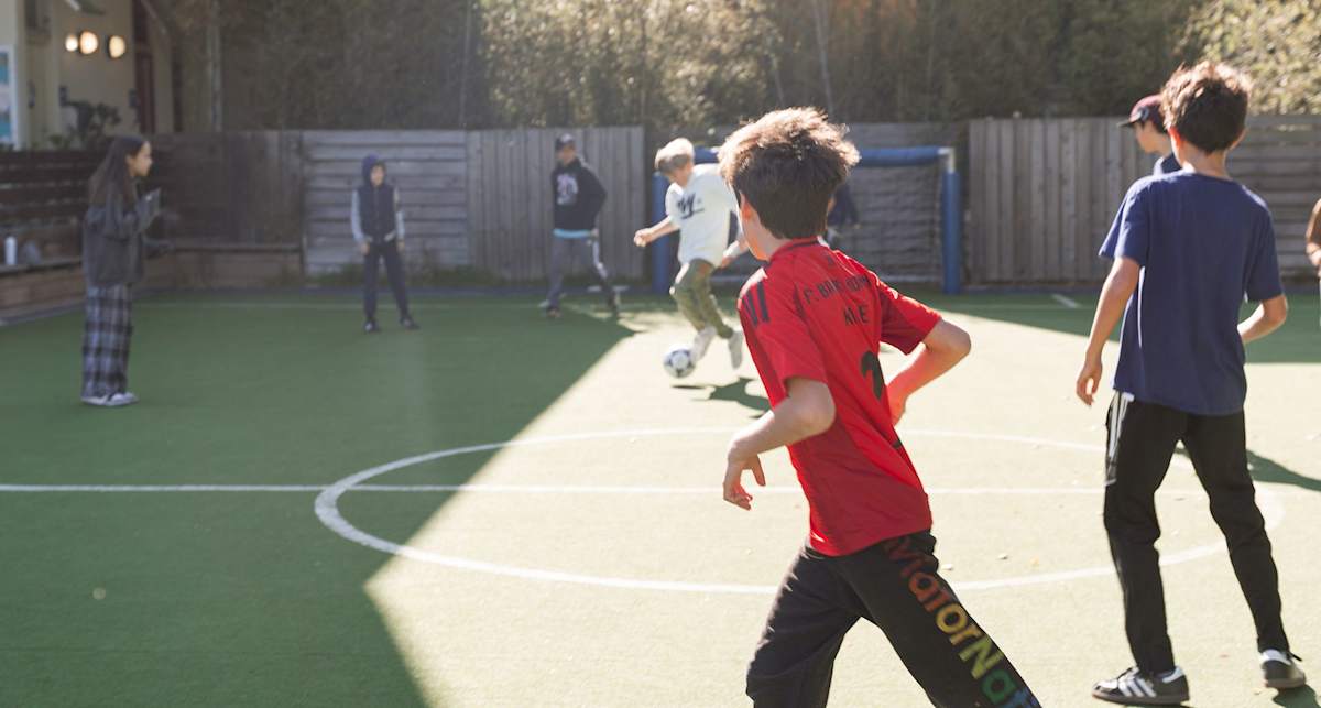 Children playing soccer in the 12th Street play yard