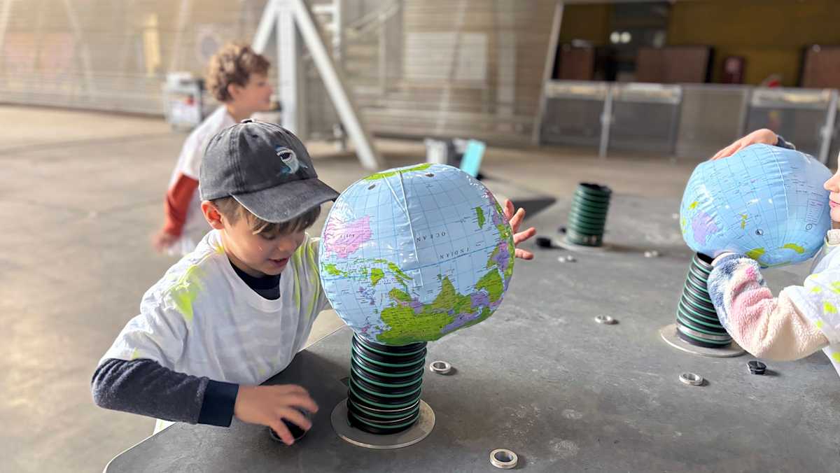 A PS1 student running a hands-on science experiment